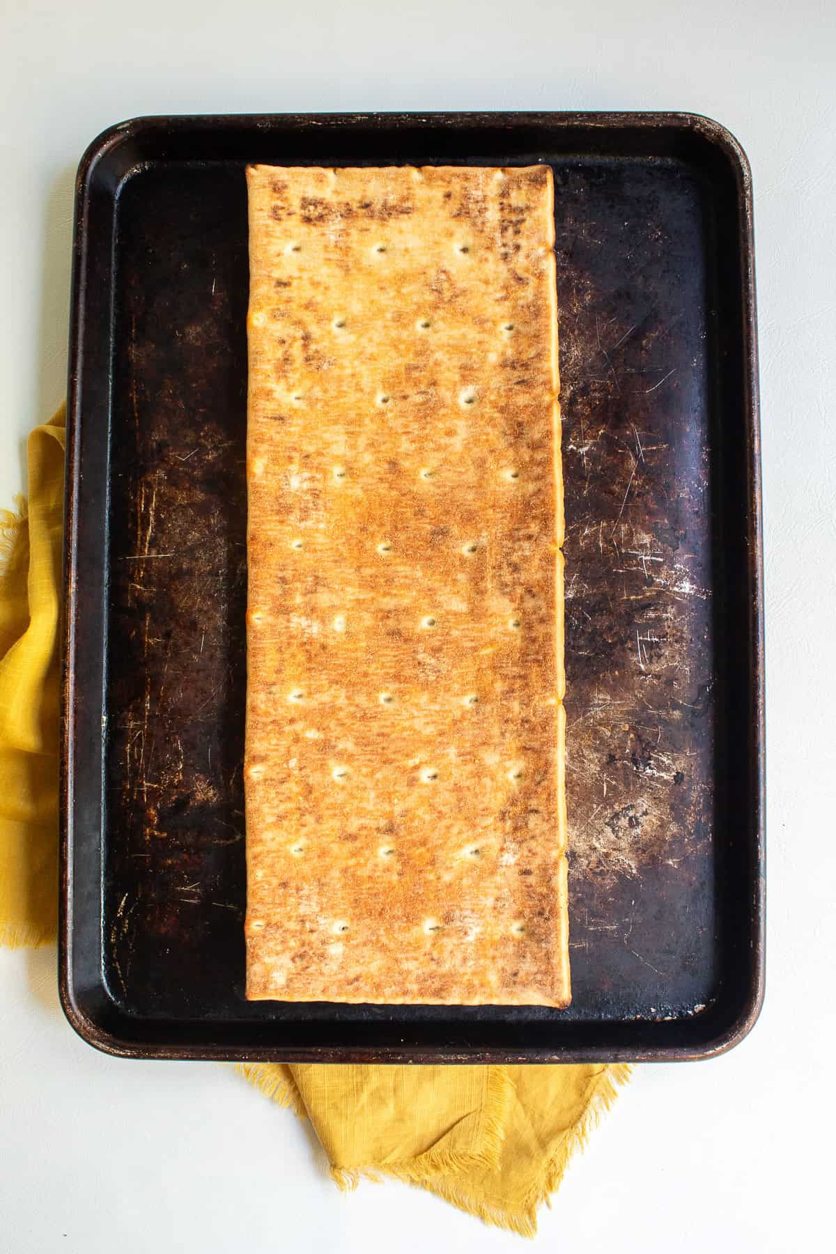 The underside of the pizza crust has been broiled until golden brown and crisp.