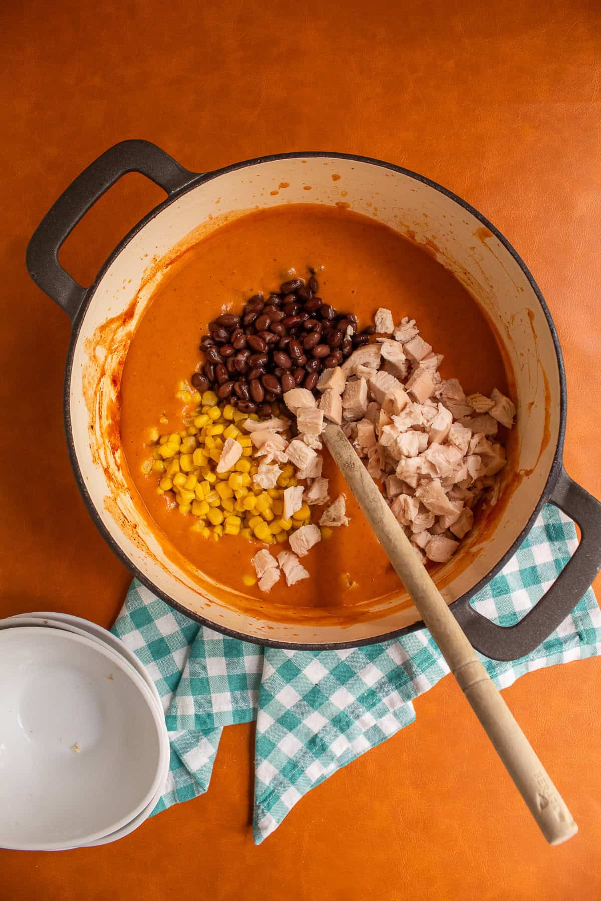 Cubed chicken, black beans, and corn are added to the blended soup.