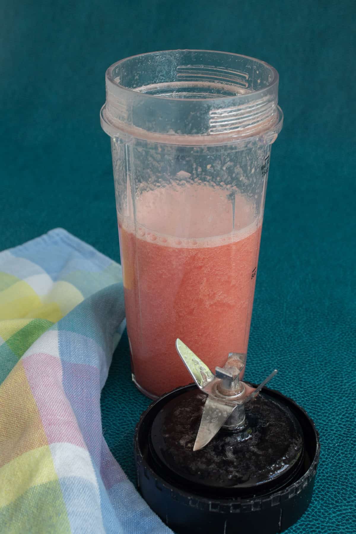 The blended lemonade concentrate is pale pink.