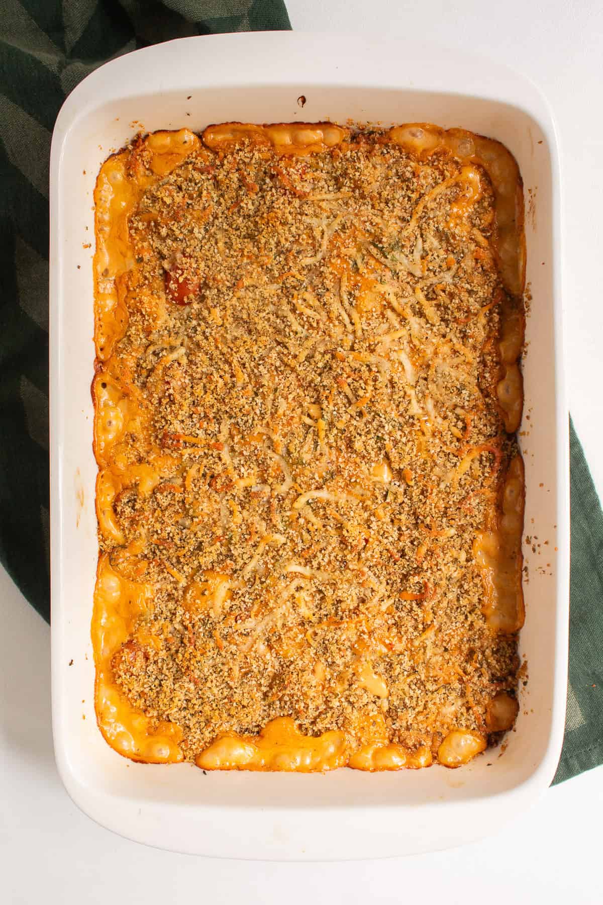 The baked gnocchi has a golden brown color and the sauce has bubbled up along the edges.