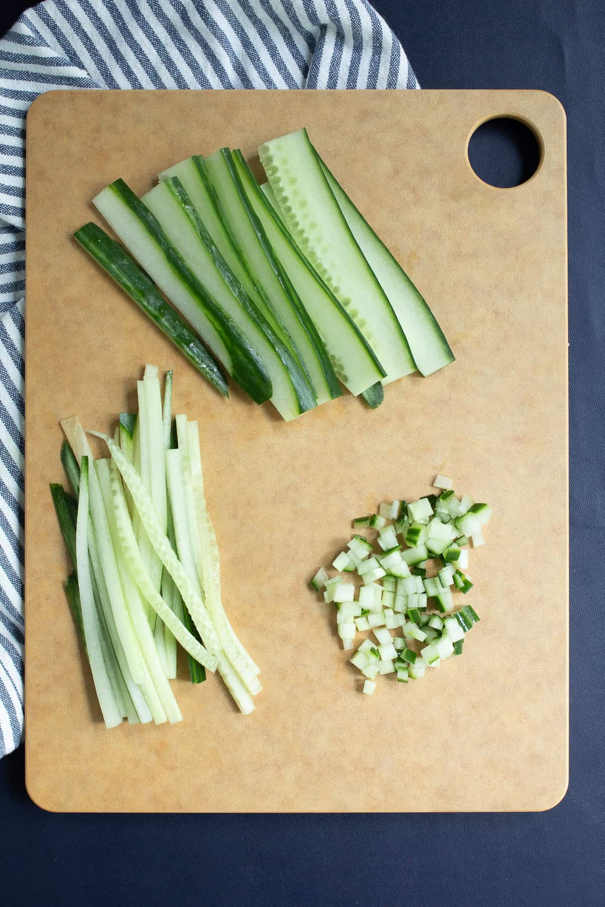 Cucumbers are cut into planks, then strips, and finally into a fine dice.