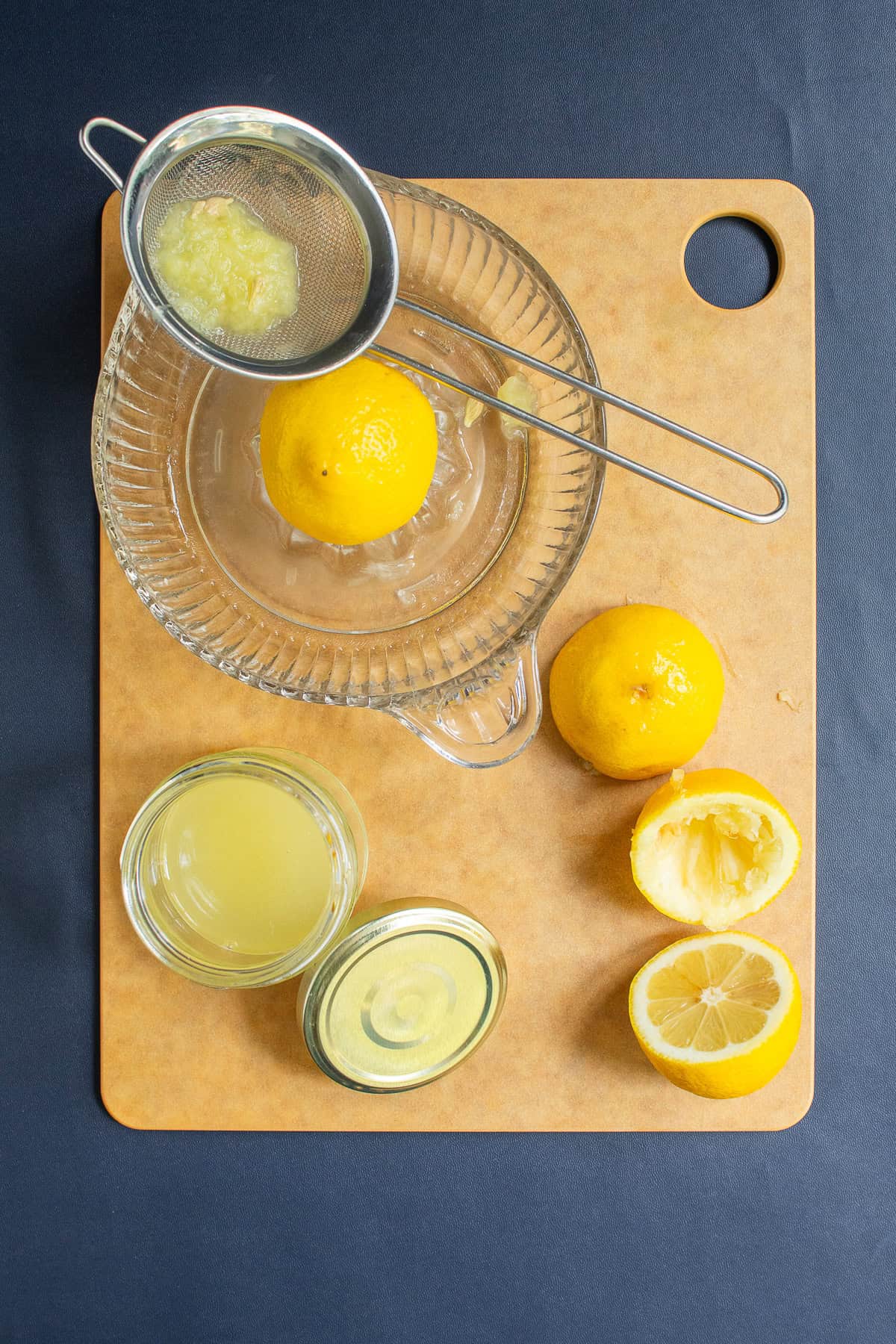 Lemons are juiced on a glass citrus reamer.