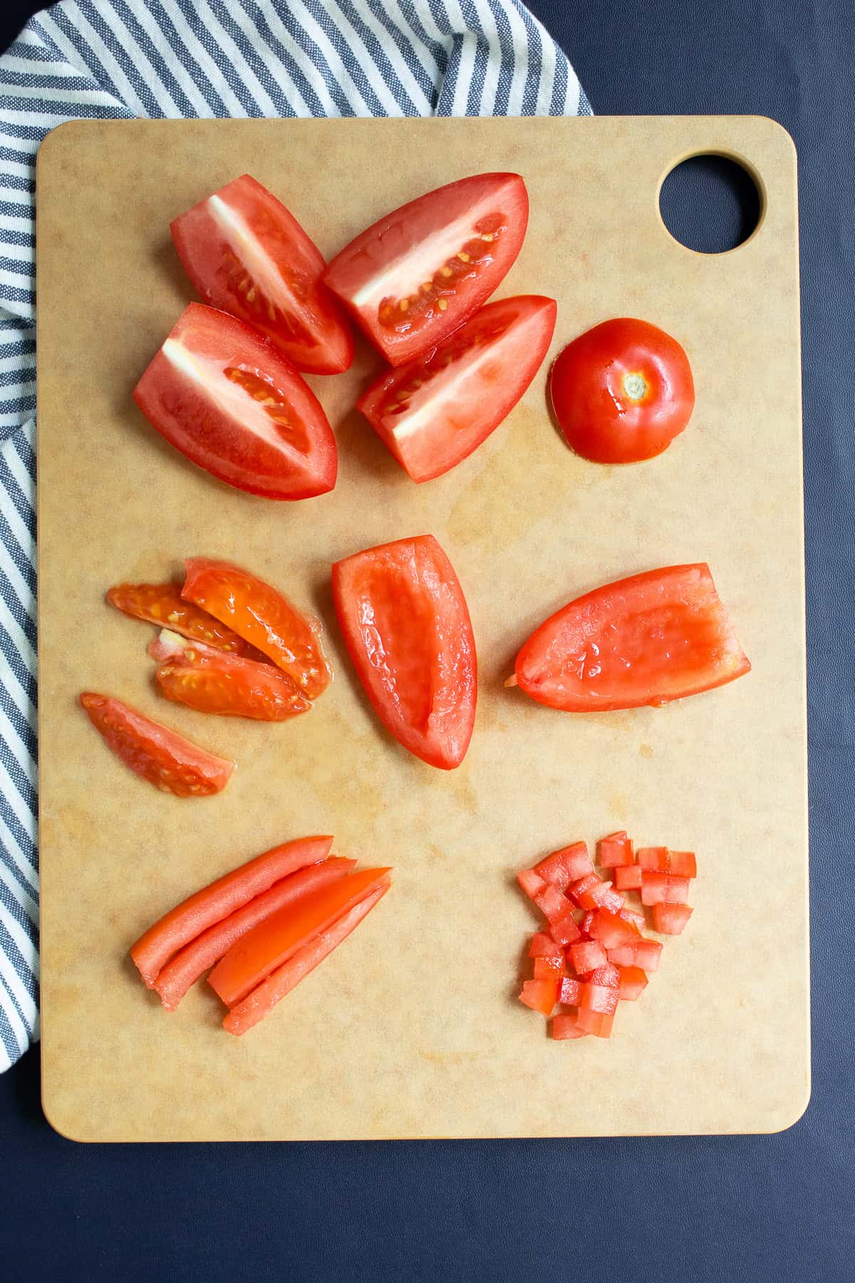 Plum tomatoes are seeded , cut into strips, and then into a fine dice.