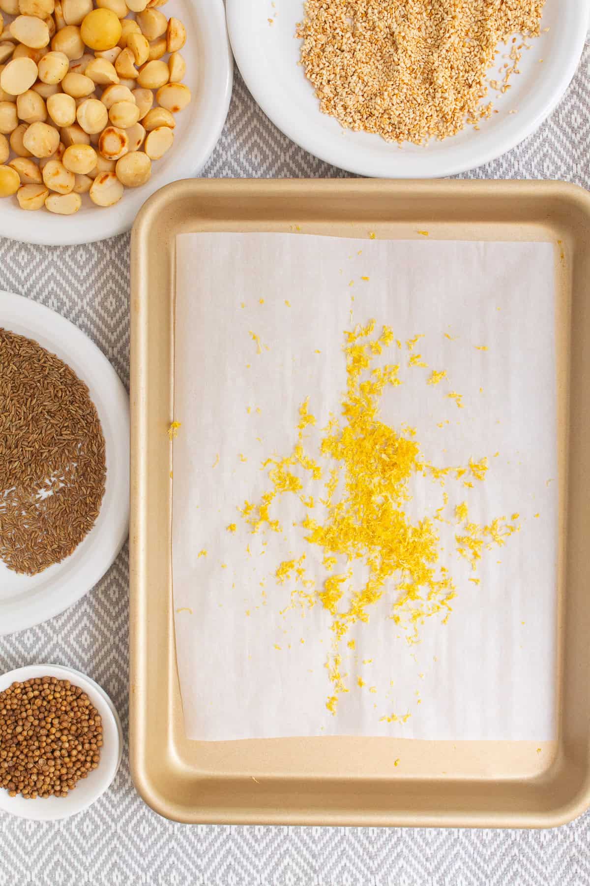 The dried lemon zest is removed from the oven to cool.