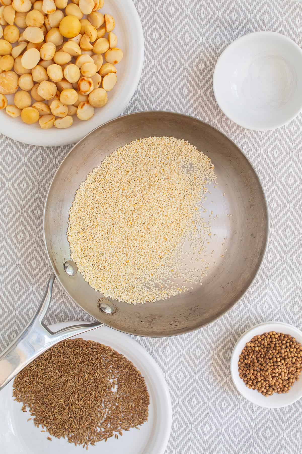 Sesame seeds are toasted in a small stainless skillet.