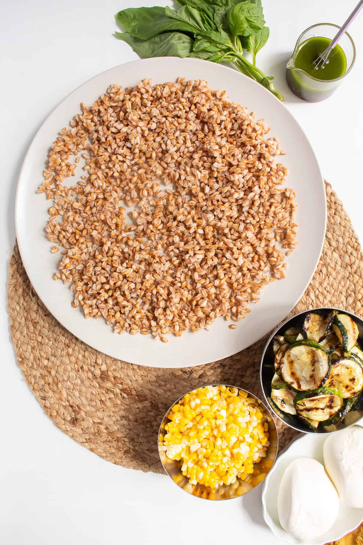 Farro is placed on a large platter as a base for the salad.