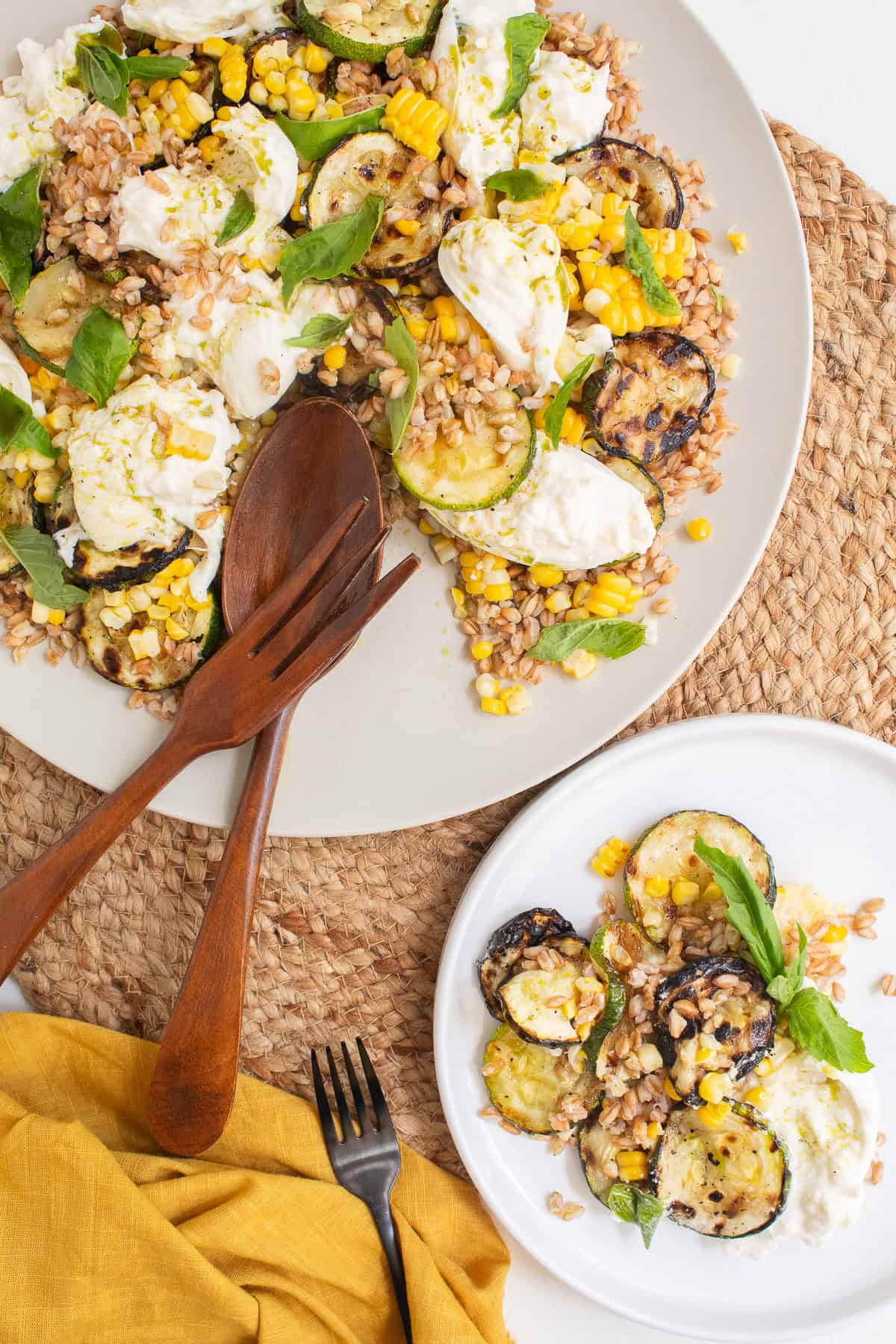 The salad is served with a wooden spoon and fork