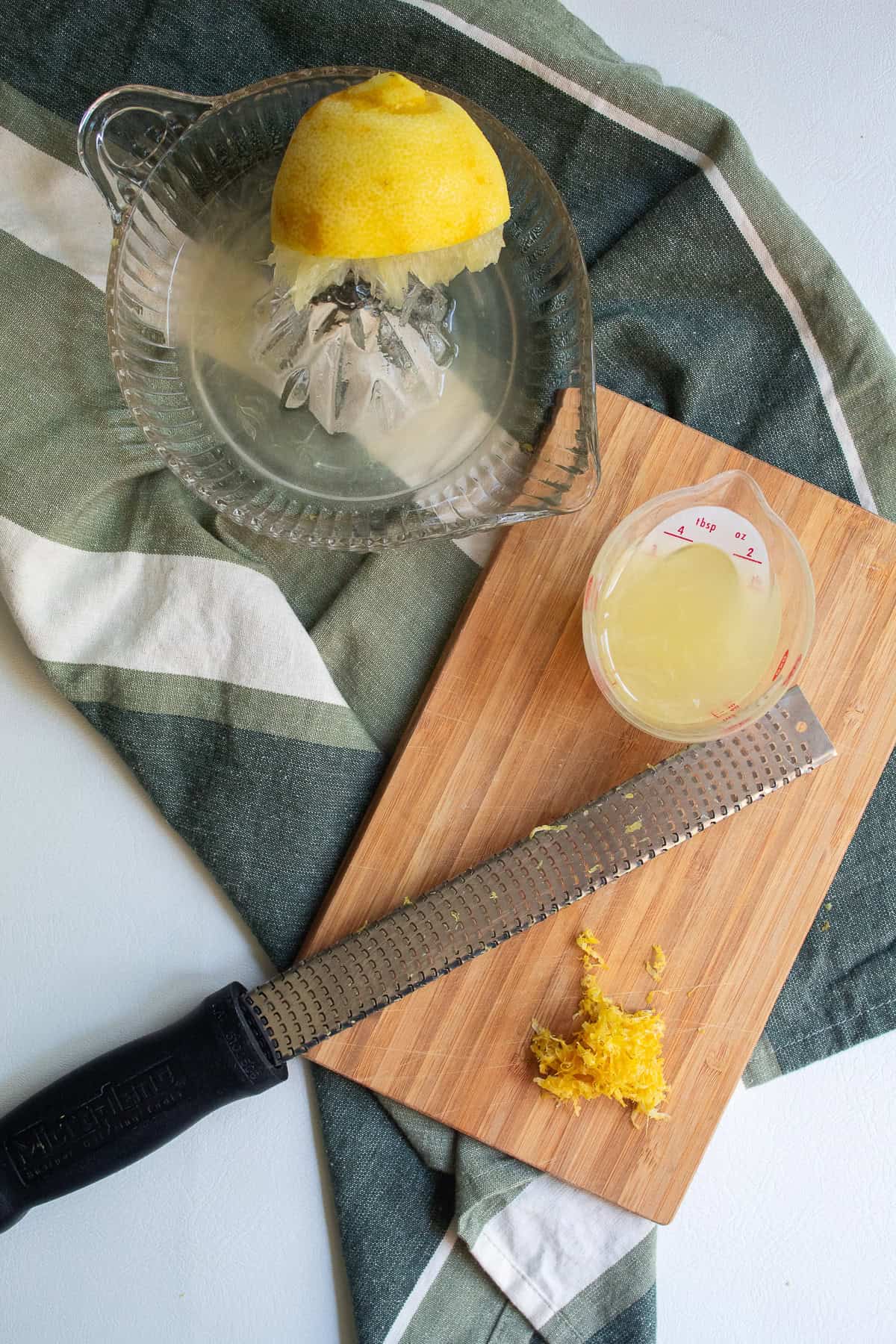 One lemon is zested with a microplane and then juiced using a glass citrus reamer.