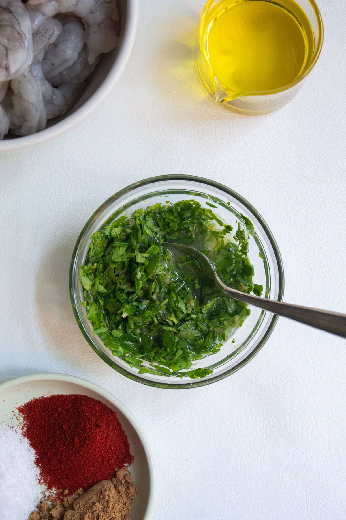 Chopped parsley, lemon zest, and lemon juice are combined in a small bowl.