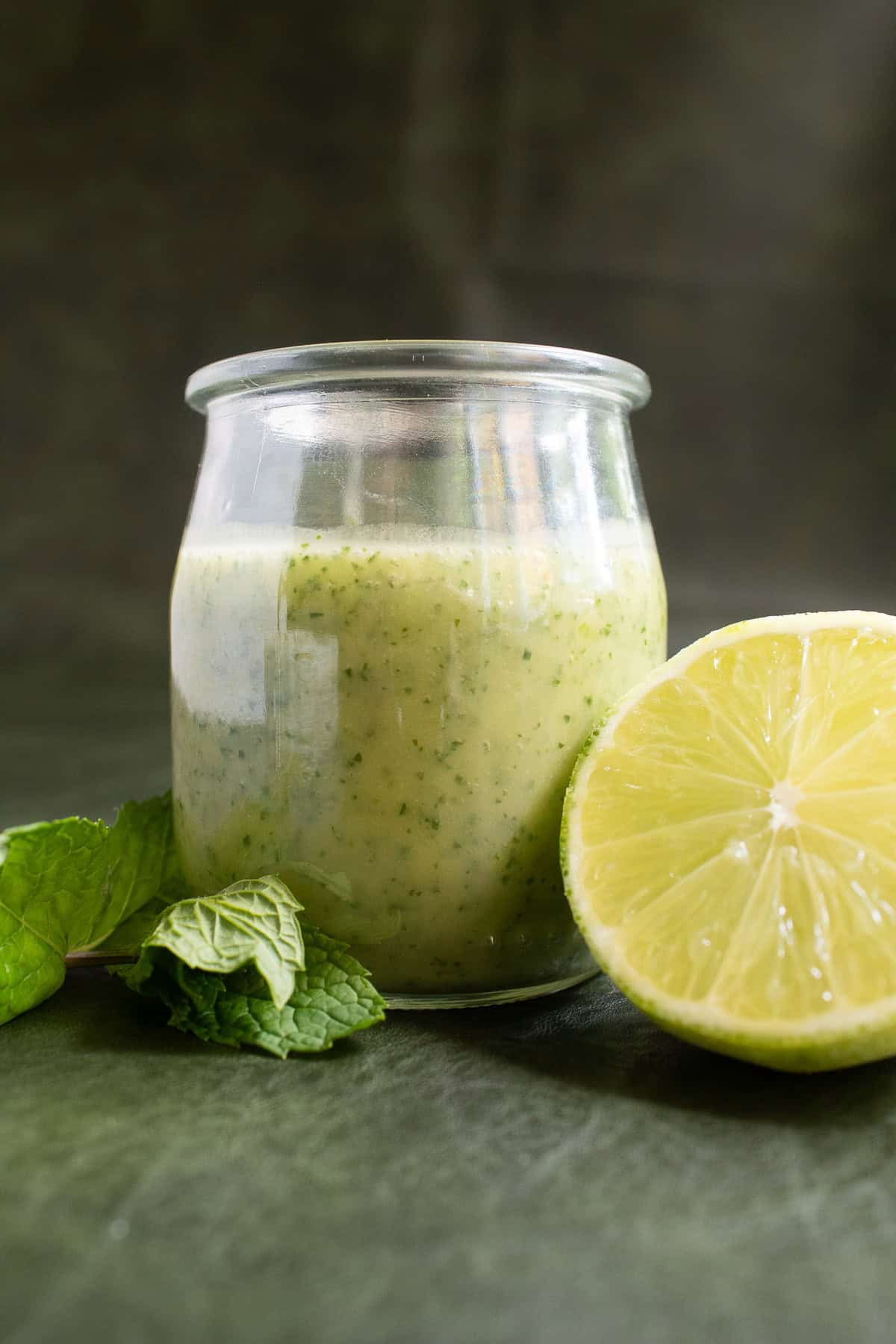 The mojito vinaigrette is a pale yellow with visible specks of lime zest and mint leaves.