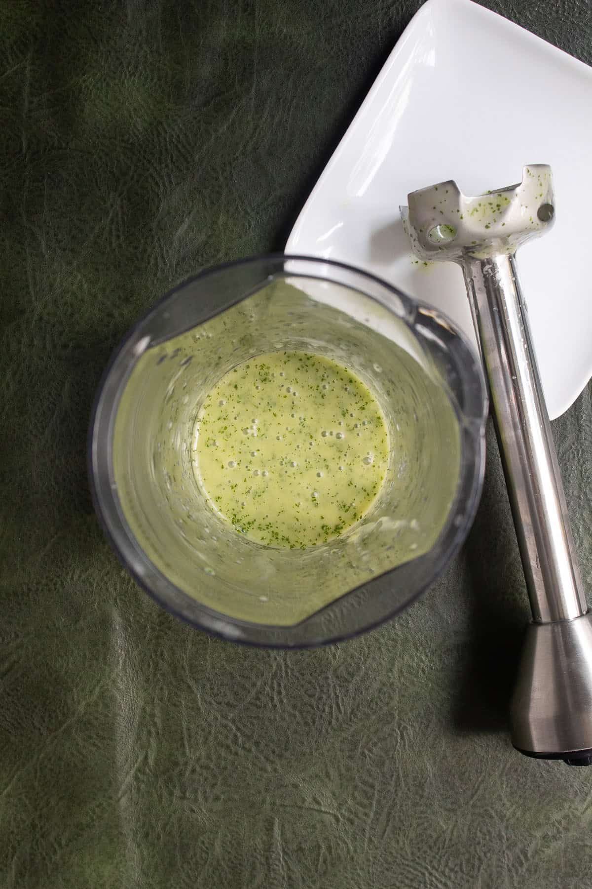 The mint, lime, and honey mixture blends up into a thick, pale green dressing.