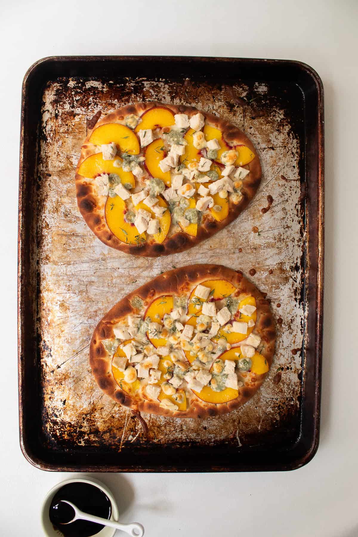 The baked pizzas have a golden crust and bubbling cheese.