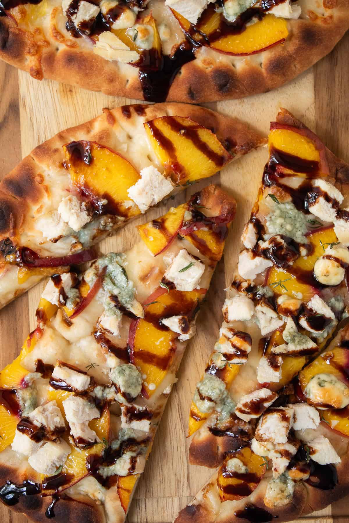 Sliced nectarine pizza can be served on a wooden tray for guests.