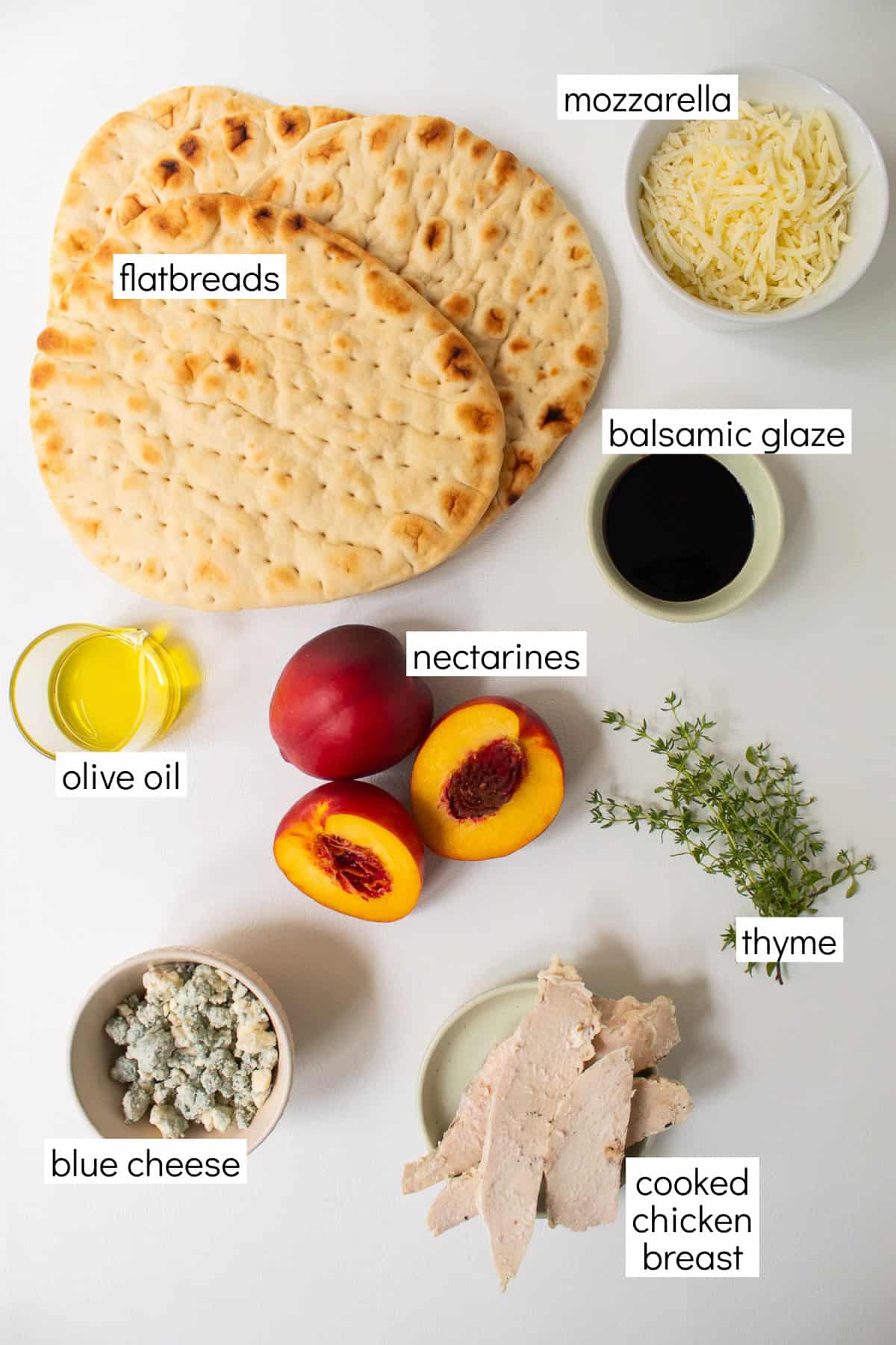 Ingredients for the recipe are displayed and labeled with white text boxes including the words flatbreads, mozzarella, balsamic glaze, olive oil, nectarines, thyme, blue cheese, and cooked chicken breast.