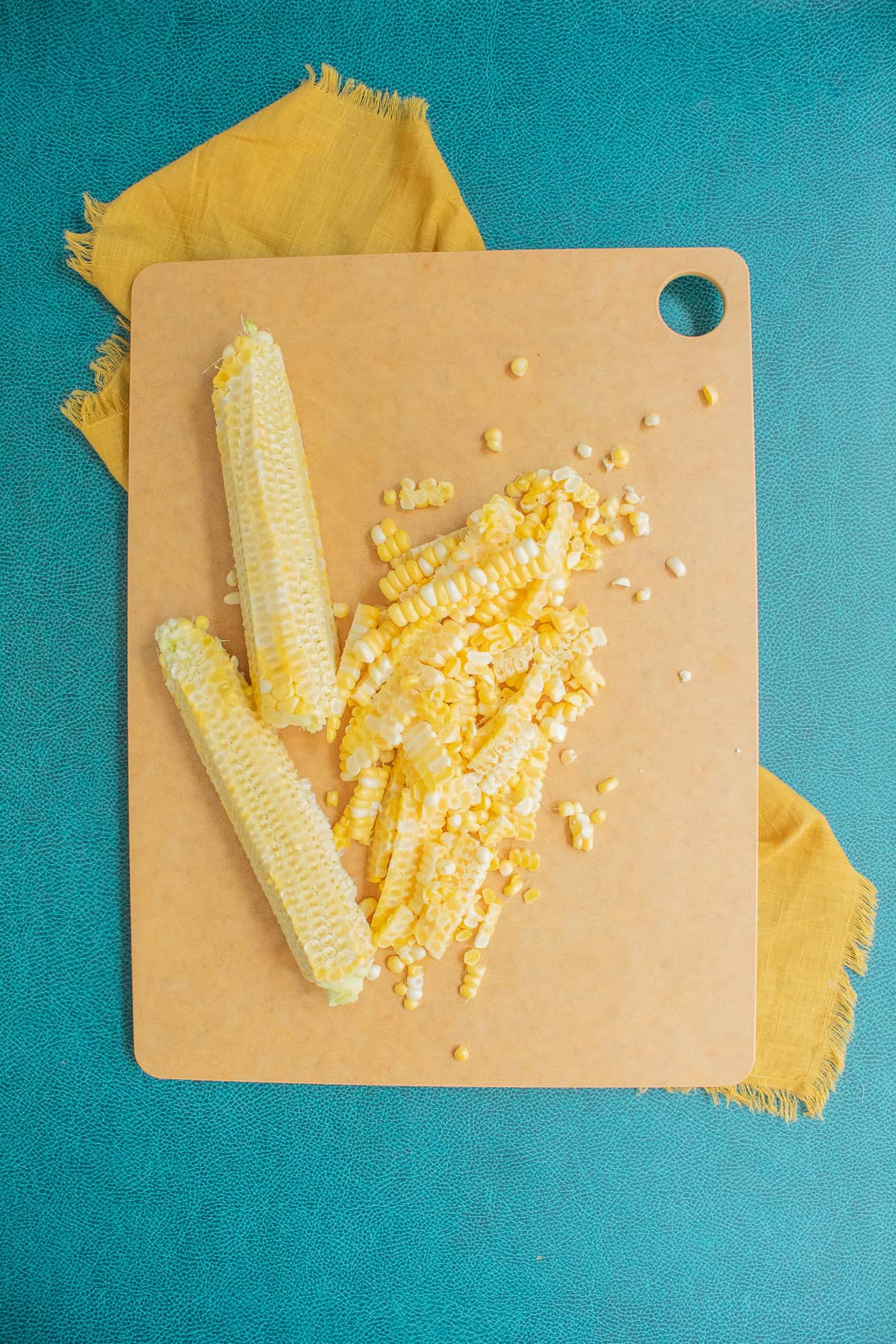 Corn kernels are cut from the fresh cobs.