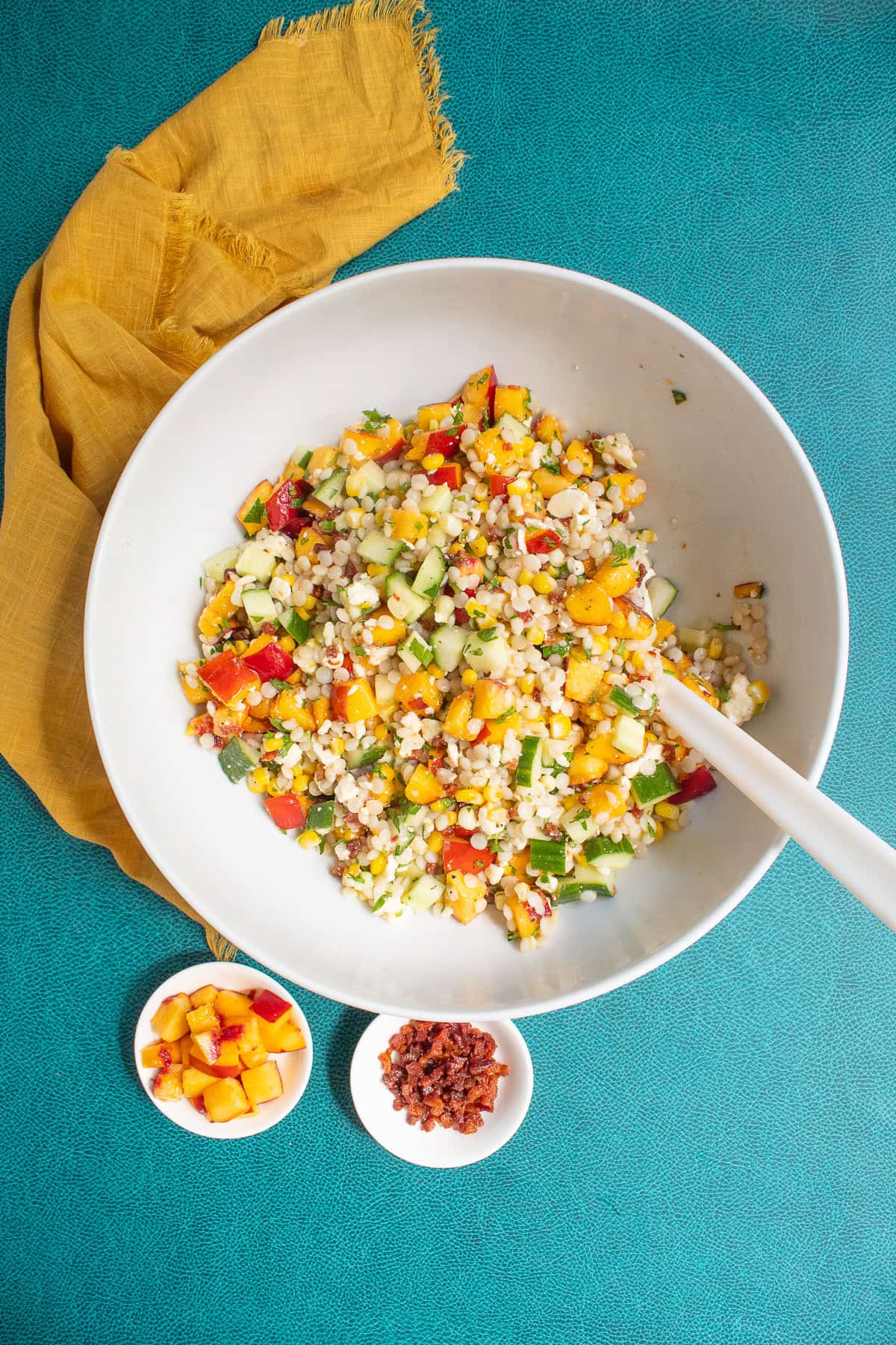 The salad components are mixed in a large white bowl.