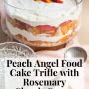 The trifle, with visible layers of cake, cream, and peaches, is displayed on a pink surface. A white text box at the bottom of the image contains the words, "peach angel food cake trifle with rosemary simple syrup" and "plan. eat. post. repeat."