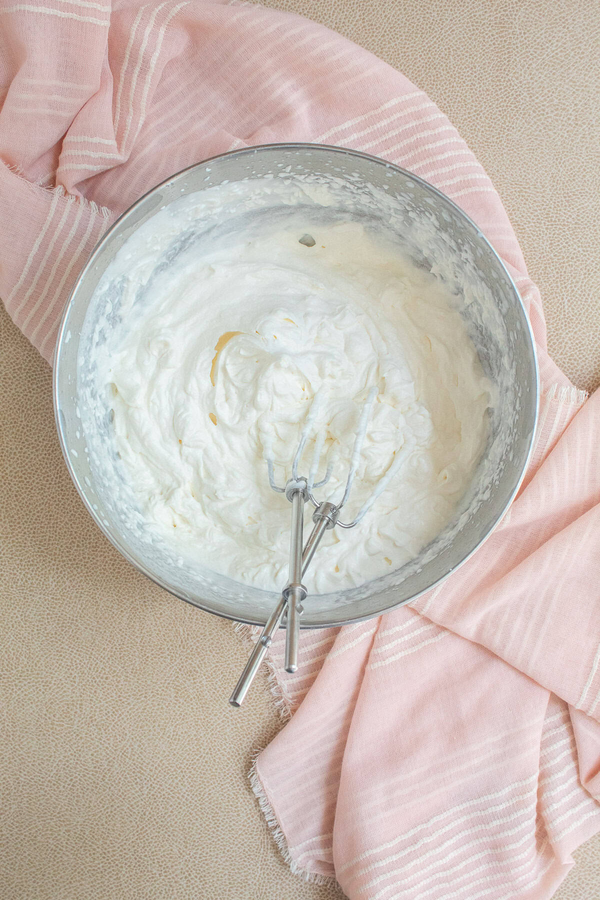 The cream is whipped into stiff peak texture.