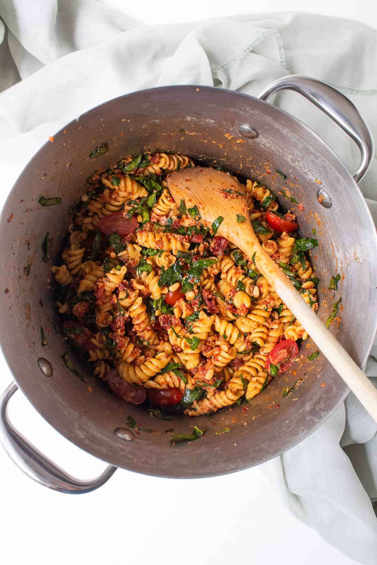 The pasta is mixed to distribute the ingredients evenly.