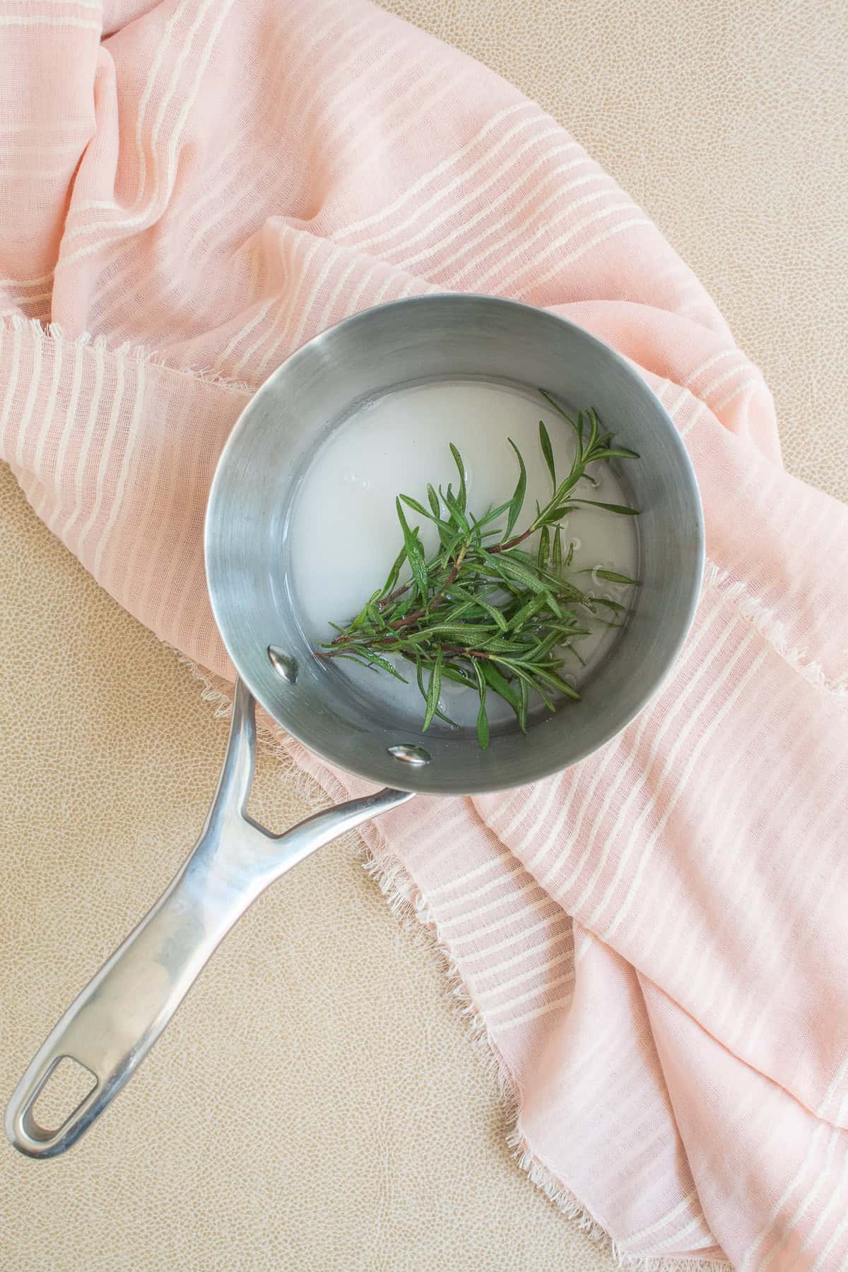 Rosemary, sugar, and water are added to a small saucepan.