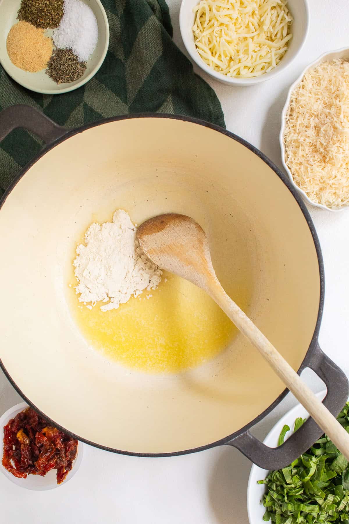 Flour is added to melted butter in the large pot.