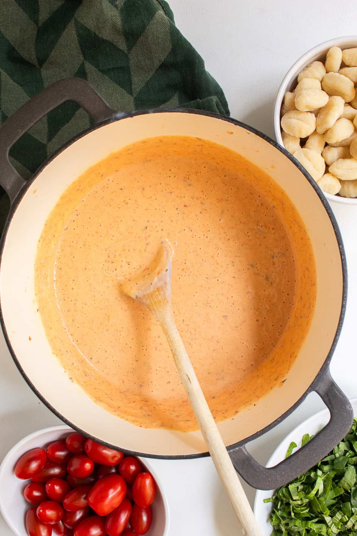 The blended sauce is thickened and a rich orange color.