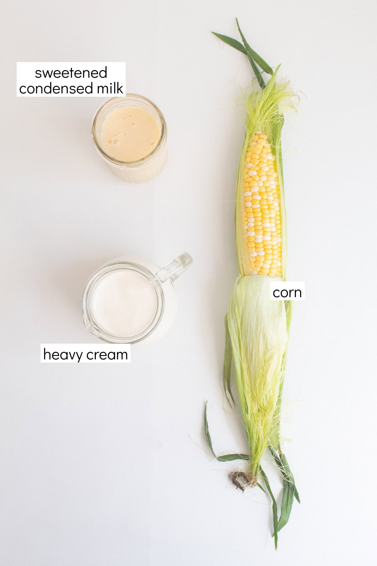 Ingredients for the recipe are displayed and labeled with white text boxes including the words sweetened condensed milk, corn, and heavy cream.