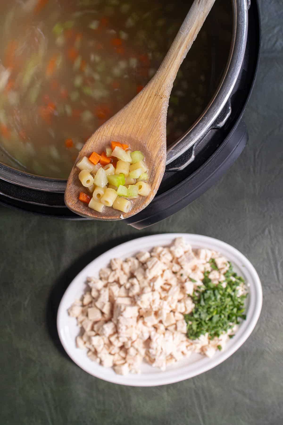 The pasta and vegetables have cooked to tenderness in the pressure cooker.