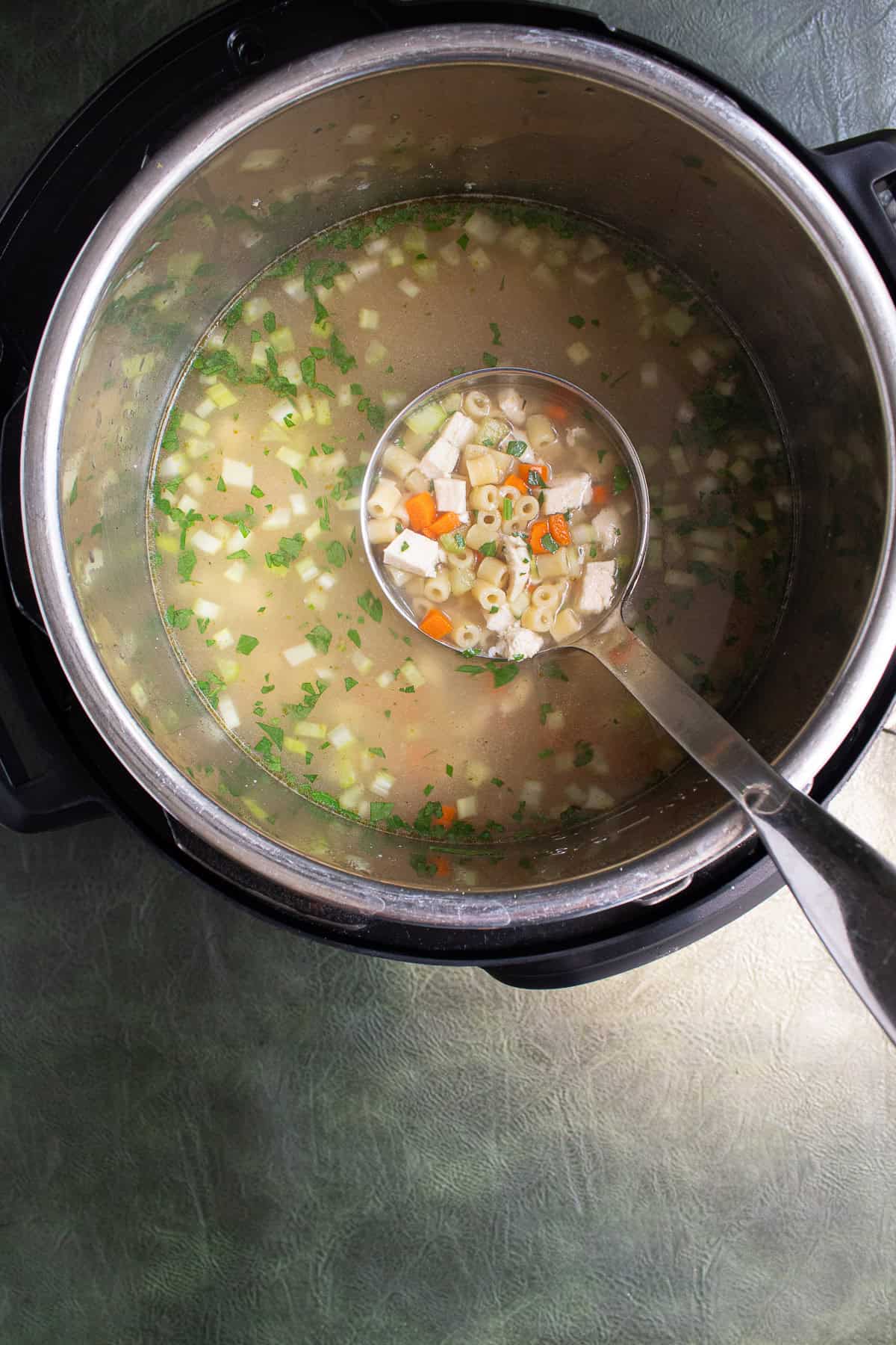 The finished soup has tender ditalini, vegetables, and bright green parsley.