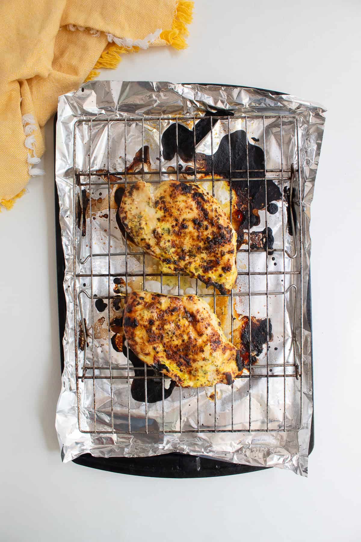 The broiled chicken breasts are lightly charred.