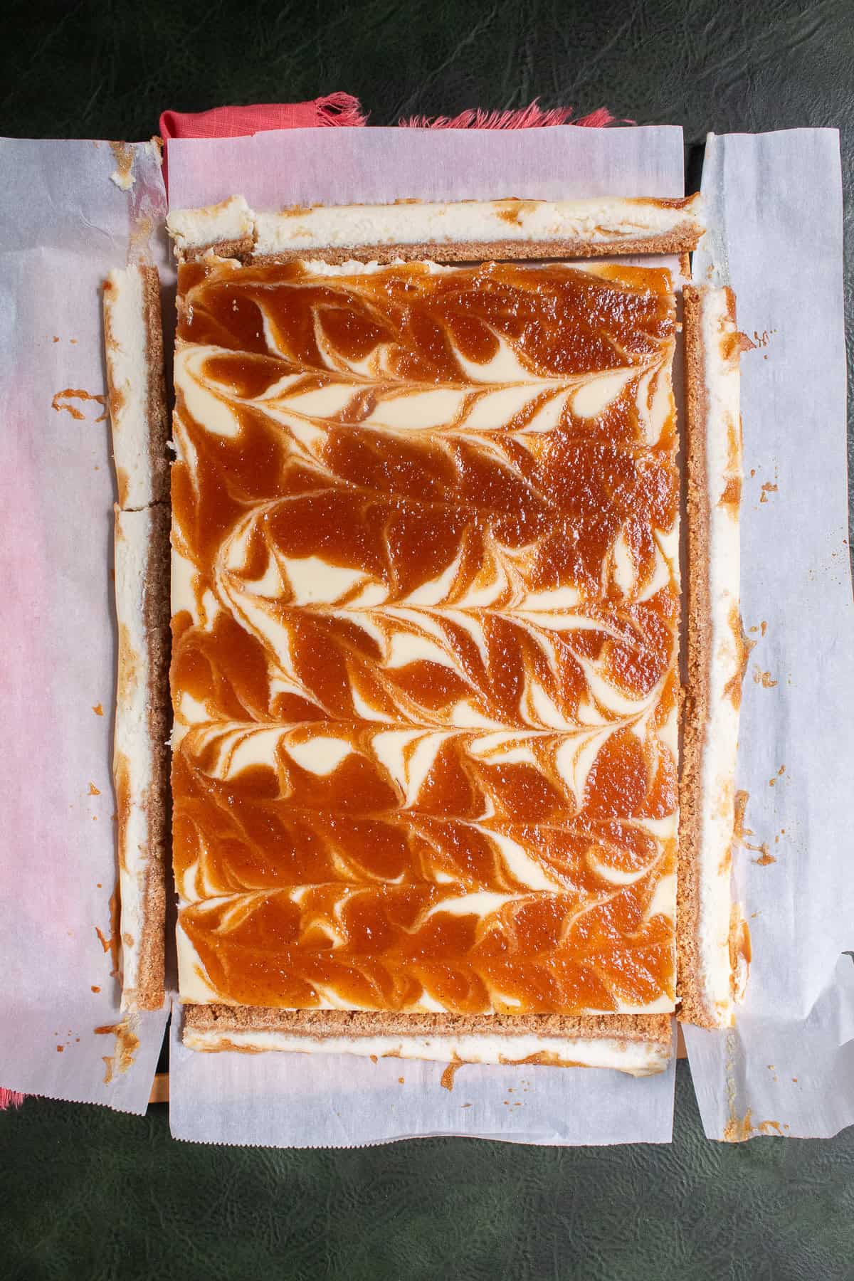The edges are cut off of the cheesecake bars.