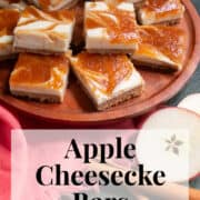 Cheesecake bars are piled high on a wooden platter next to a coral colored napkin and apple slices. A white text box at the bottom of the image contains the words, "apple cheesecake bars" and "plan. eat. post. repeat."