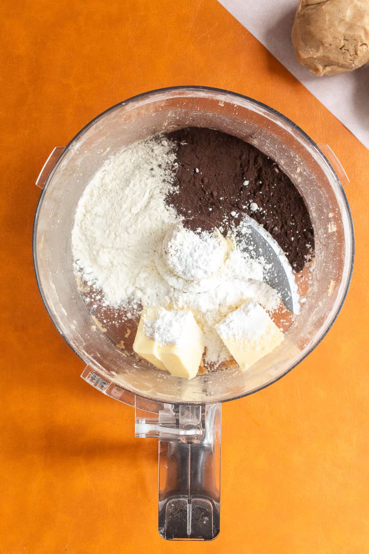 Ingredients for the chocolate shortbread dough are added to a food processor.