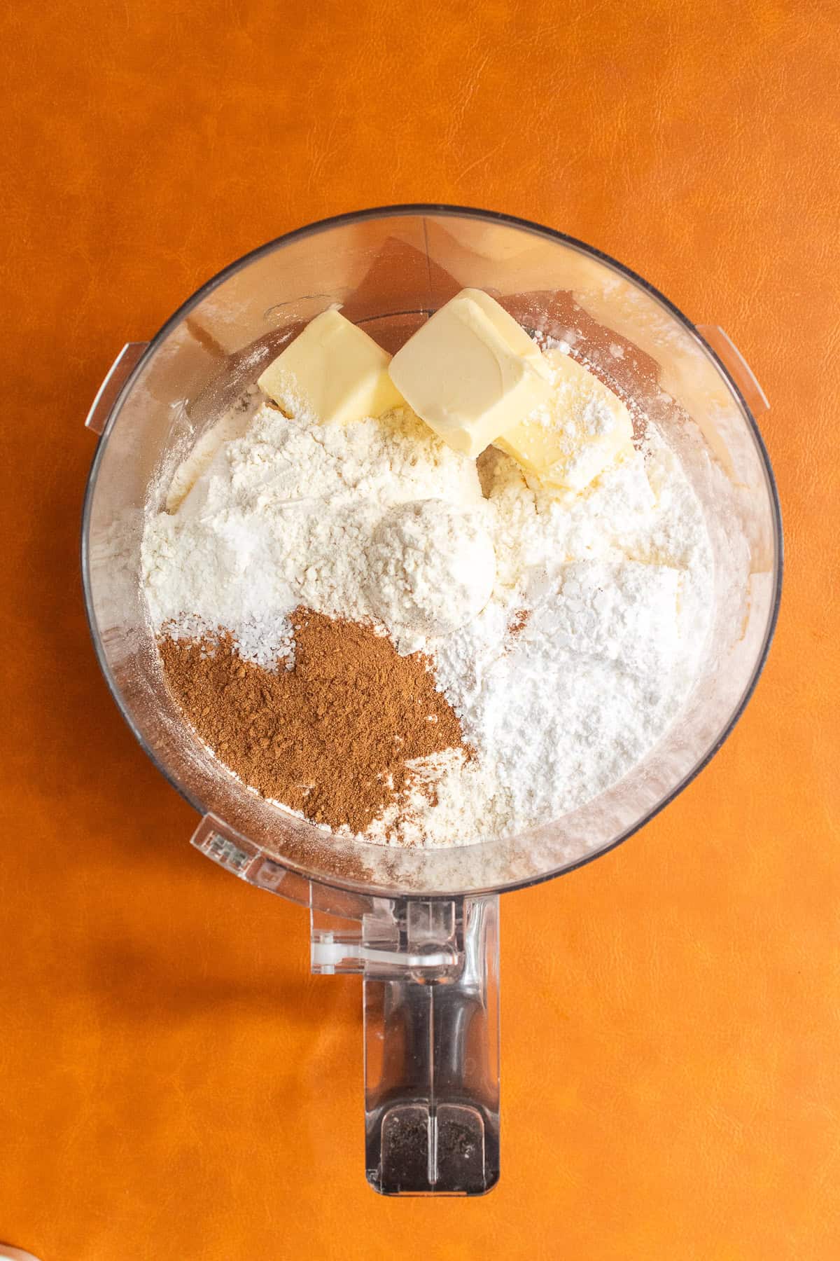 Ingredients for the spiced shortbread dough are added to a food processor.