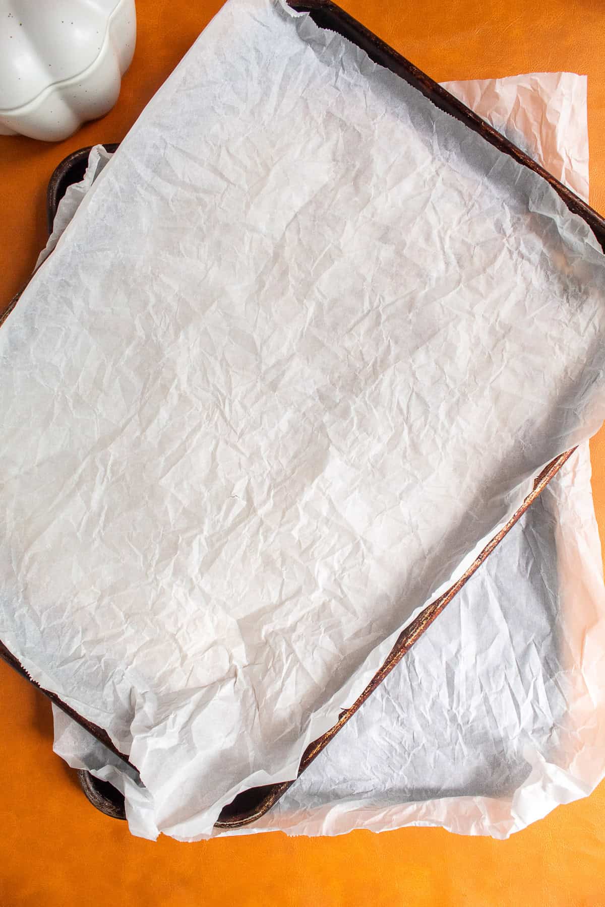 Two sheet pans are lined with parchment paper.