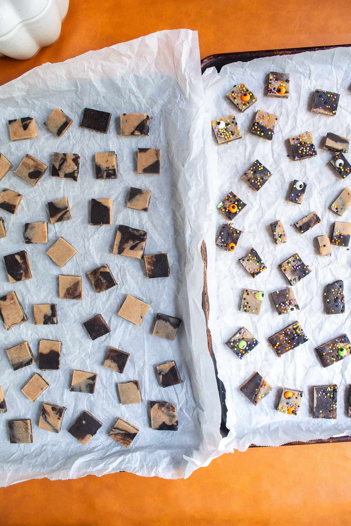 The chilled dough squares are placed on two parchment lined baking sheets.