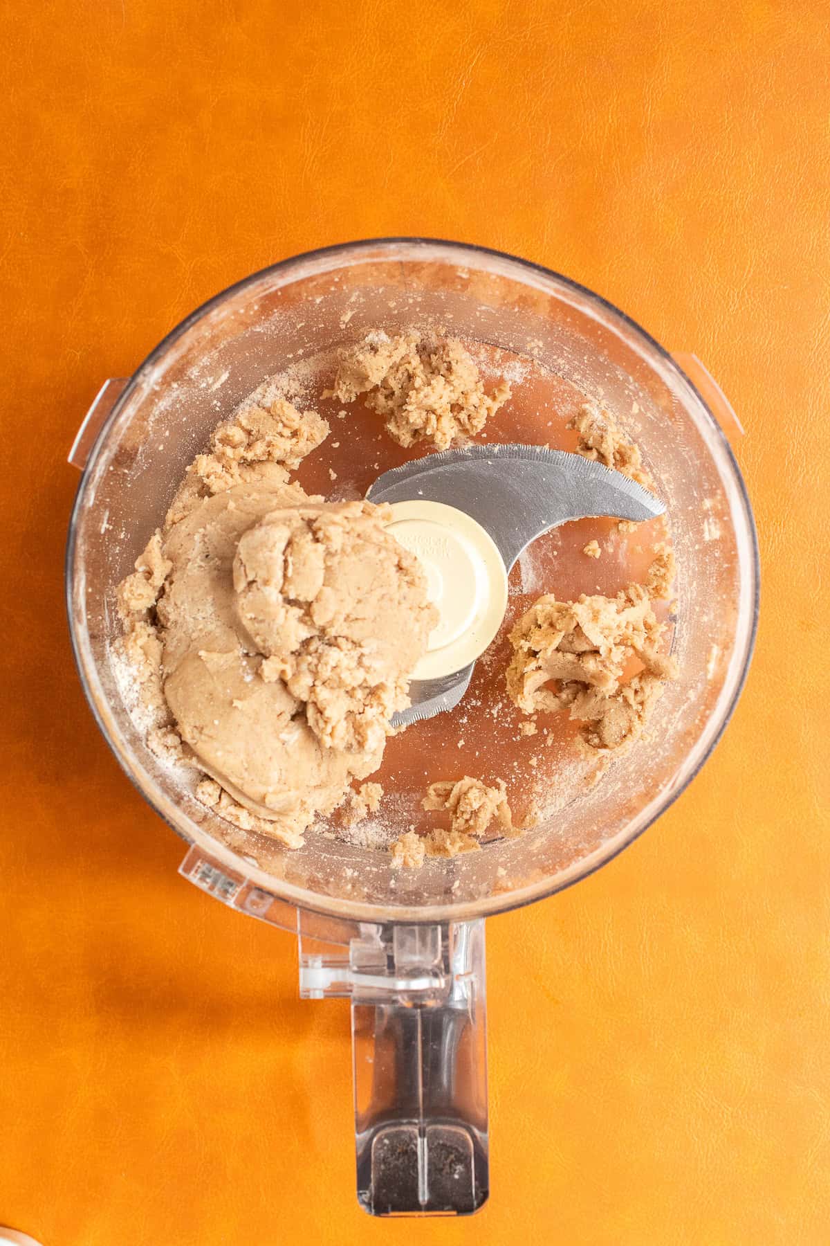 The pumpkin spice dough comes together into a ball in the food processor.