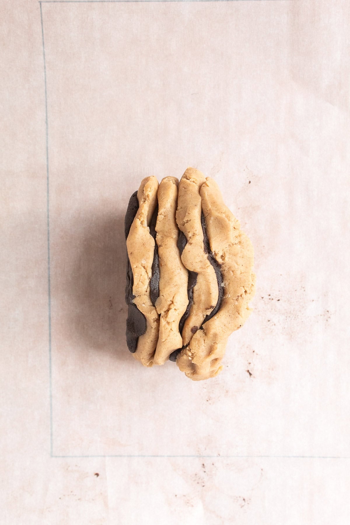 Alternating chocolate and spiced dough pieces are stacked.