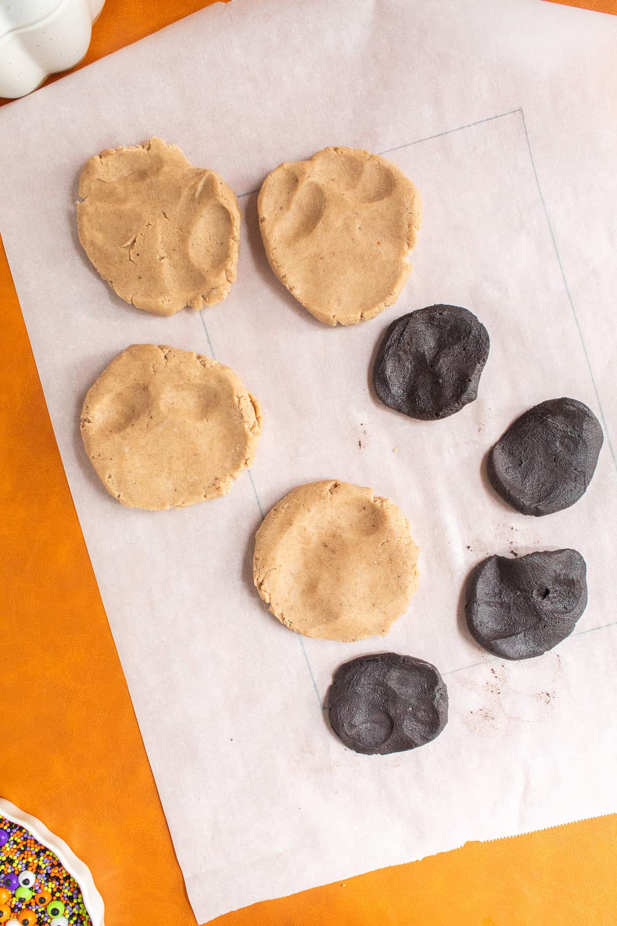 Each of the eight dough balls are pressed into flat pancake shapes.