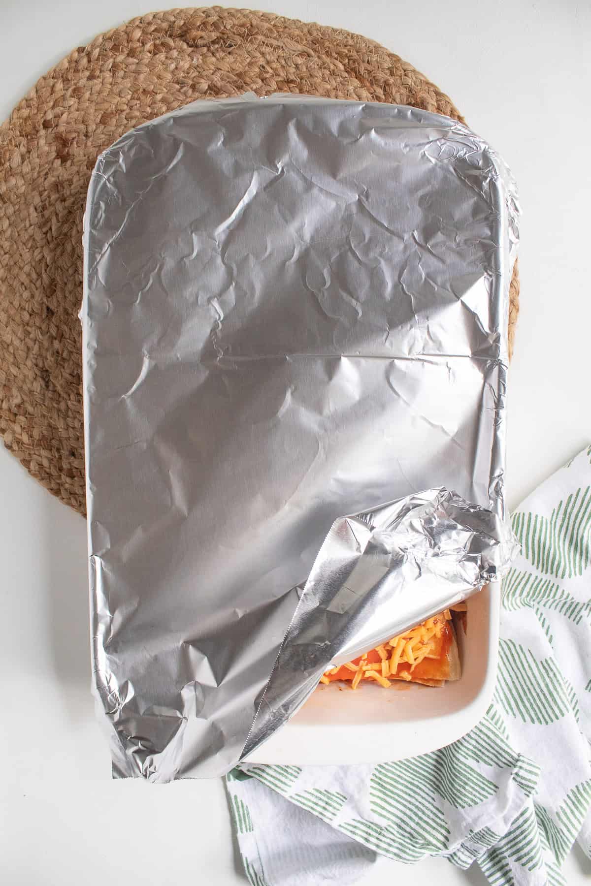 The casserole dish is covered in foil before baking.