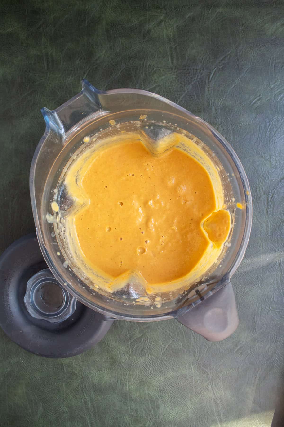 The blended soup is a bright orange color.